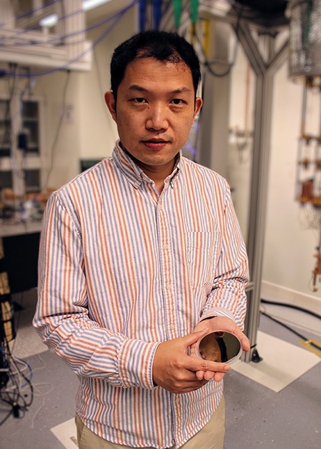 Tian Zhong standing in lab