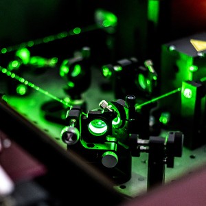 Lasers reflecting on optic table in quantum laboratory
