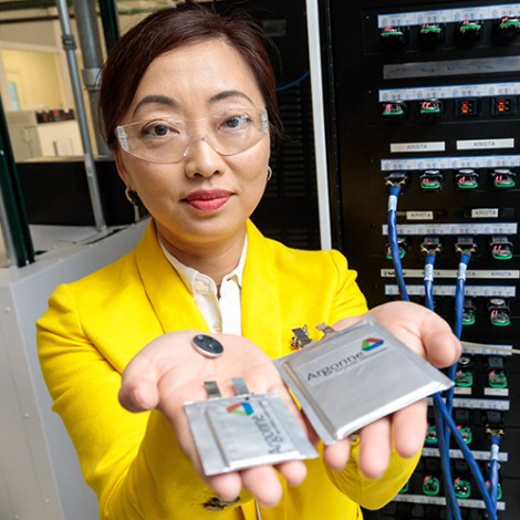 Shirley Meng holding two battery protoypes